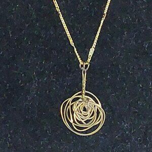 28" Goldtone chain necklace with 1 1/2 " hand wire wrapped rose pendant.